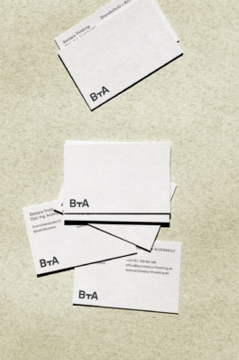 Image of BTA business cards laying on a creme coloured ground